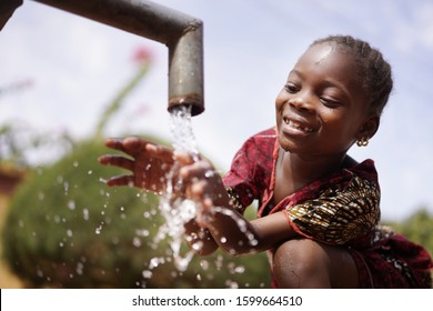 Water is Life for African Children, Little Gorgeous Black Girl Drinking from Tap