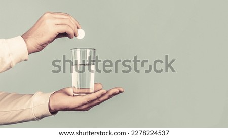 Water in man hands. Health concept. Close up of man holding a pill. Glass of water tablet. Glass with efervescent tablet in water with bubbles. Imagine de stoc © 