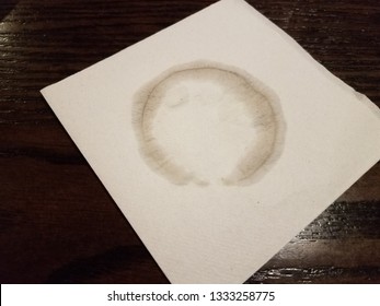 Water Mark Or Ring From Cup Or Glass On White Napkin On Brown Table