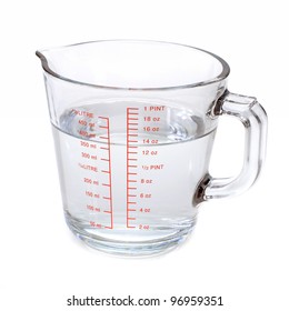 Water in measuring cup isolated on white background
