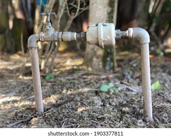 Water Meter Outside The House. Measuring Device, Open Cover Of Water Meter To Check Counter Number Of Water Consumption, Water Pipe And Meter With Waterspout Of Home.