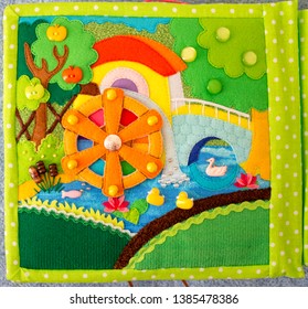 Water Mill. Handmade Kids Fabric Textile Cotton And Felt Quiet Book. Fragment With Handwork  Elements.