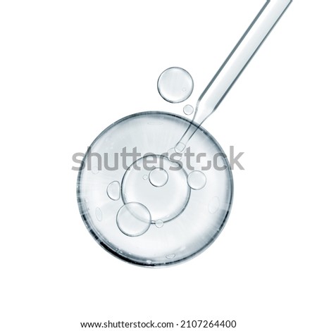 water miracle bubble or cosmetic liquid serum drops with laboratory glass pipette on white background. Beauty and skincare