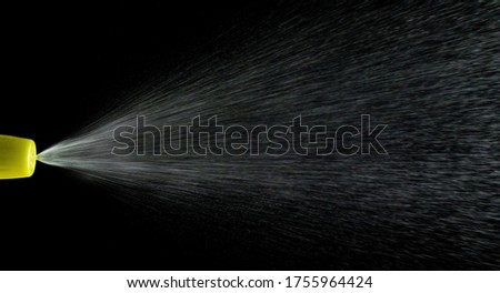 Water mist splash bottle isolated on black background. Spray liquid aerosol for perfume.