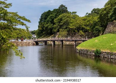 Water Moat With An Old Wooden Bridge In Hikone Castle