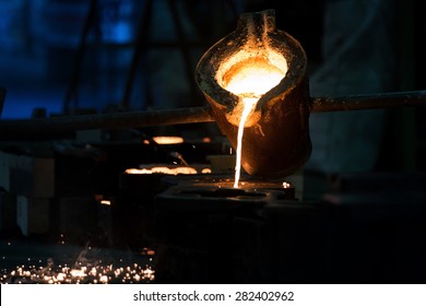 Water molten metal Being poured from the crucible Into the sand mold - Powered by Shutterstock