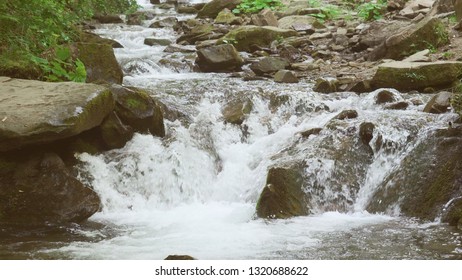 Water from mountain river flow down into pool. Beautiful nature in mountain area