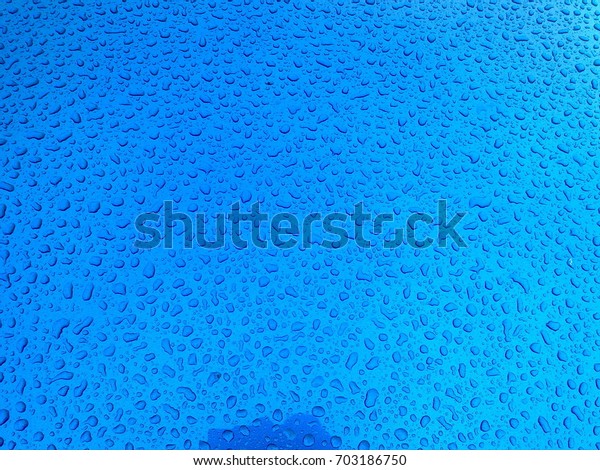 Water on a blue car\
bonnet