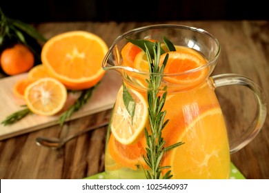 Water With Orange, Lemon And Mandarin Slices In A Glass Jug