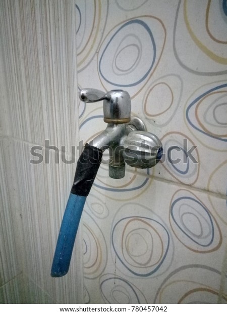 water outlet in damaged bathroom in connection with\
blue pipe