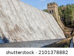 Water overflowing Derwent Dam in Derbyshire UK into Ladybower reservoir