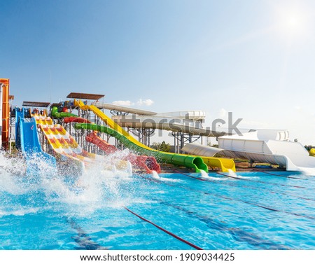 Water park, bright multi-colored slides with a pool. A water park without people on a summer day.