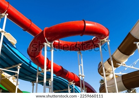 Water park recreation playground, with bright multi-colored slides without people on a summer day
