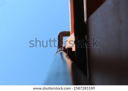 The water pipe system from the upper floor of a building. It looks like a sewage pipe.