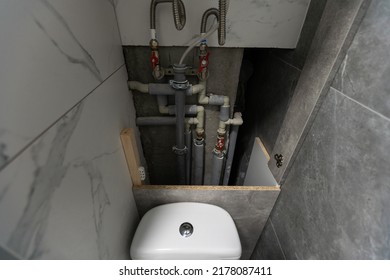 Water Pipes, Valves And Manometers Inside House, System With Electric Pumps And Heaters. Metal Pipeline Of Home Boiler, Cold And Hot Tubes On Utility Room Wall. Modern Pipe Installation For Heating