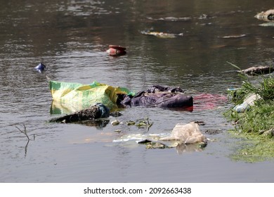 Water Pollution, Garbage And Trash, Discarded Plastic Bag Debris Polluting A Waterway