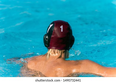 Water Polo Goalie Number 1 Treads Water In Swimming Pool While Wearing Black Uniform.