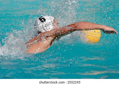 Water polo player swimming for the ball