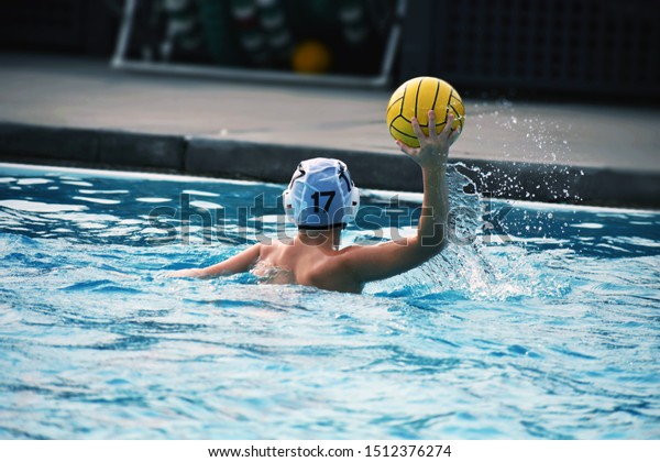 Water polo player throwing\
ball