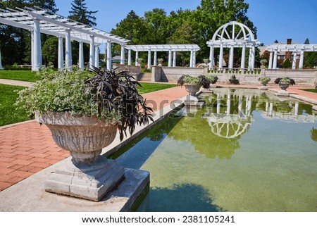 Water pool along stone path leading to gorgeous outdoor wedding spot with pergola