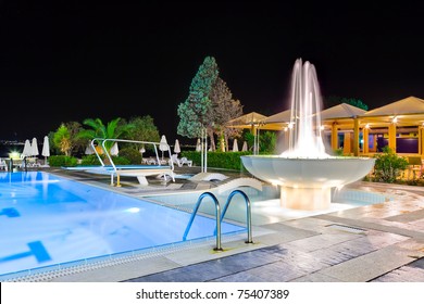 Water pool and fountain at night - vacation background