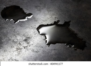 Water Is Poured On A Black Kitchen Counter