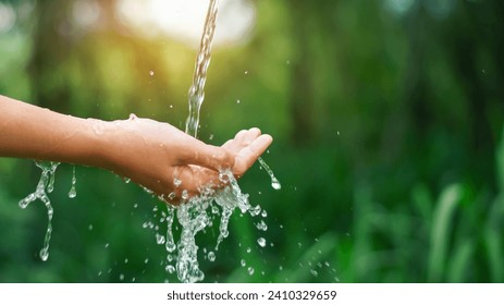 water pouring flow on woman hand on nature background - Powered by Shutterstock