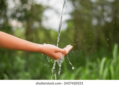 water pouring flow on woman hand on nature background - Powered by Shutterstock