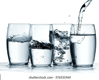 Water Pouring In Four Glasses