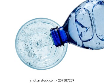 Water Pouring Into A Glass From A Plastic Bottle, Top View