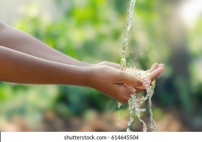 Water Pouring In Kid Two Hand On Nature Background