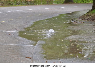 Water pours out of the ground after a water main breaks