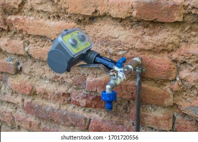 Water Pressure Regulator Installed On A Tap Set On A Brick Wall