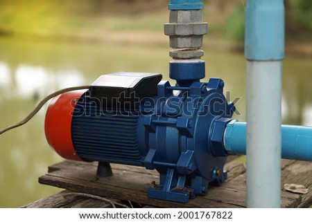 Water pump motor for Water supply system from pool to agriculture area  of the rural villager in Thailand. Concept for agricultural technology. Engine in daily life.                      商業照片 © 
