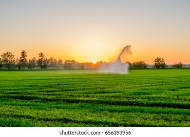 water pump at sunset in a big green field Europe - Shutterstock ID 656393956