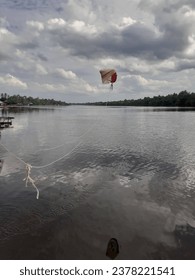 a water quality sampling device hovering above the river