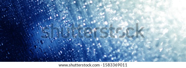 Water\
rain drops  blue Vintage on glass wall  on car  rain drops on clear\
window  or rain droplets on glass Of Raindrops Or Vapor Trough\
Window Glass Water droplets blue and Rain\
droplets