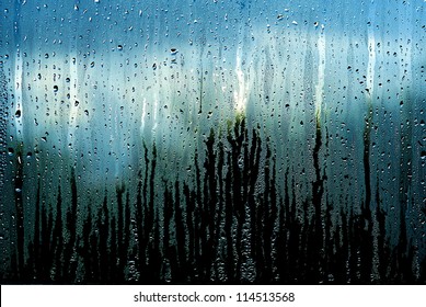 Water and rain drops on the glass, abstract view, Drops of rain on blue glass background / drops on glass after rain