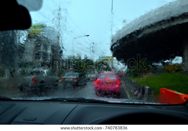 Water Rain on Car Window when Traffic Jam on the\
Road in Evening Bangkok\
Thailand