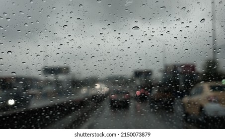 A Lot Of Water Raindrops On A Car Windscreen During A Cloudy Day. Moody Weather. Driving In Powerful Rain.