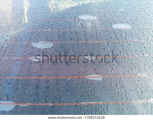 Water raining at car
window morning time