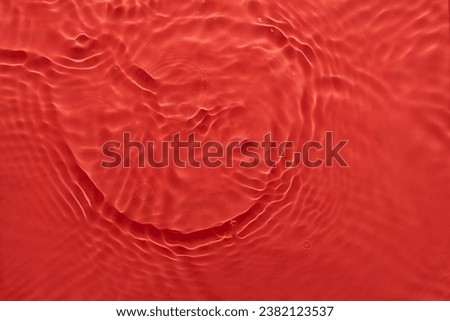 Water red surface abstract background. Waves and ripples texture of cosmetic aqua moisturizer with bubbles
