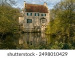 Water reflection on the moat of House Dellwig moated castle in Dortmund in springtime                               