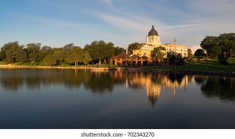 Water Reflects The American Flag Waving In Front Of The Capitol Dome In Pierre, SD