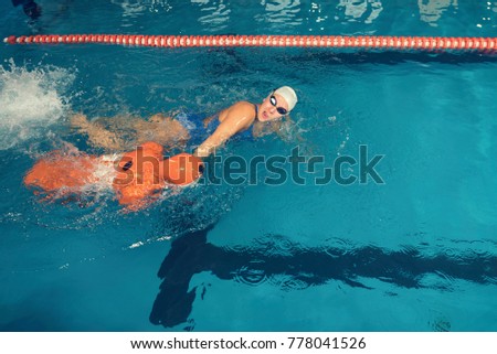Water Rescue Training Trainer and Training Dummy in a Pool Selective focus