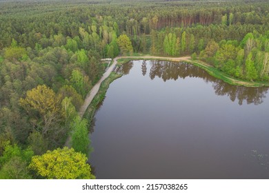 A Water Reservoir, A Lagoon Located In The Forest. The Shores Are Covered With Trees. A Small Hydroelectric Power Plant Is Visible. Photo From The Drone.