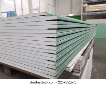 water resistant plasterboard sheets stacked in a hardware store. dry gypsum plaster. building material for the arrangement of cladding, partitions, ceilings in buildings. - Shutterstock ID 2259851675