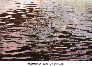 Water ripples reflecting canyon walls and vegetation - Shutterstock ID 2232846083