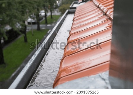 Water from the roof drains into the drain chute, rainy weather