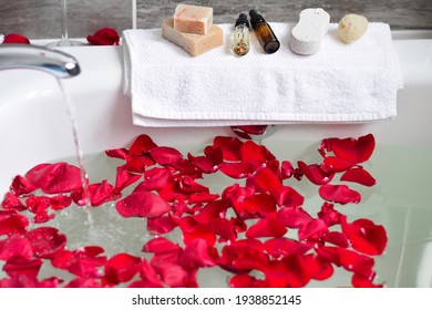 Water Running Filling Up Bathtub Filled With Red Rose Petals